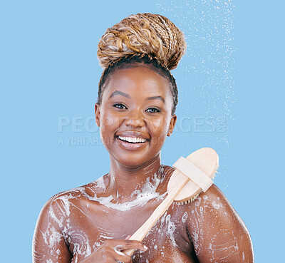 Buy stock photo Studio portrait of an attractive young woman showering against a blue background