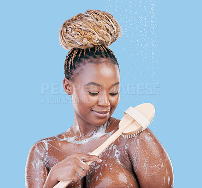 Buy stock photo Studio shot of an attractive young woman showering against a blue background