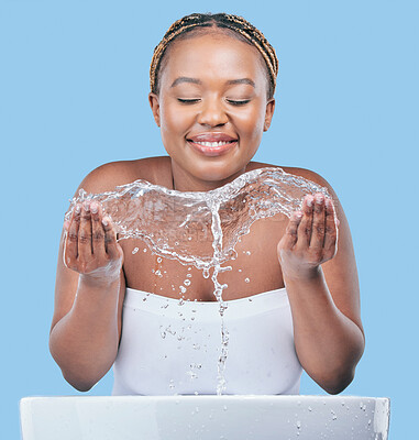 Buy stock photo Water splash, skincare and black woman in studio with natural, beauty and facial routine. Cosmetic, dermatology and African female person washing face with h2o liquid in basin by blue background.