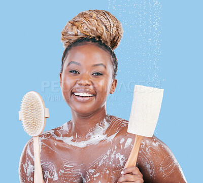 Buy stock photo Studio portrait of an attractive young woman showering against a blue background