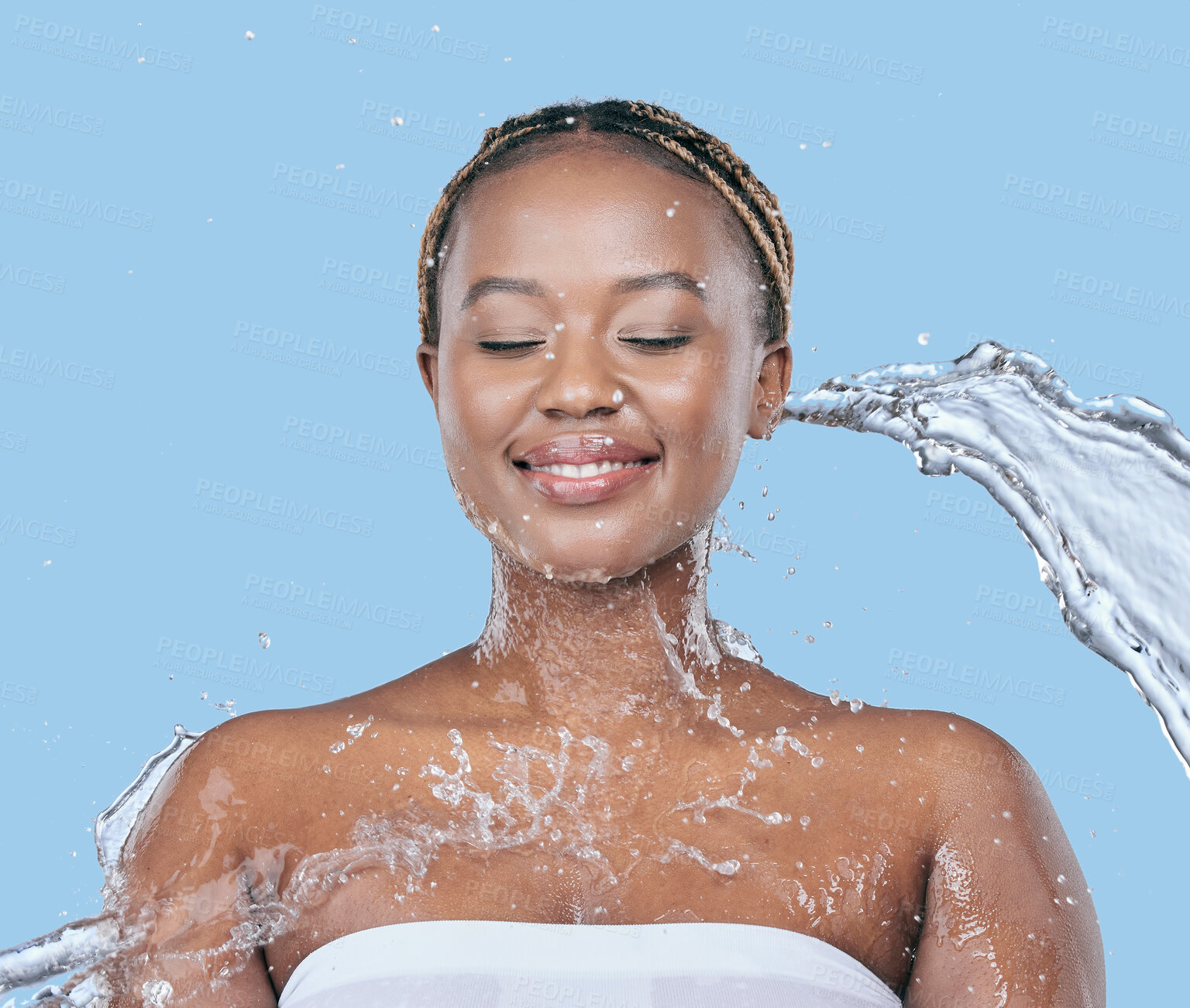 Buy stock photo Water splash, health and black woman in studio with natural, beauty and facial routine for wellness. Cosmetic, dermatology and African female person washing face with h2o liquid by blue background.