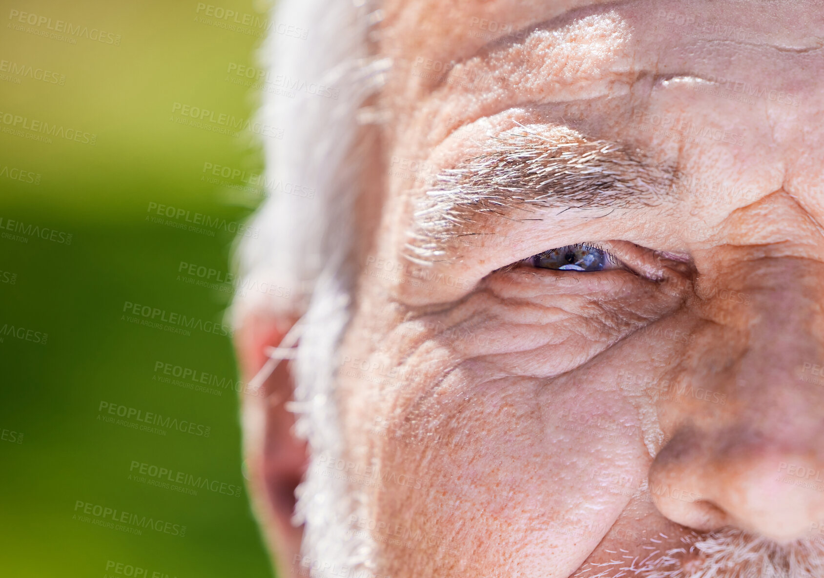 Buy stock photo Cropped shot of an unrecognisable man looking into the camera during a day outside