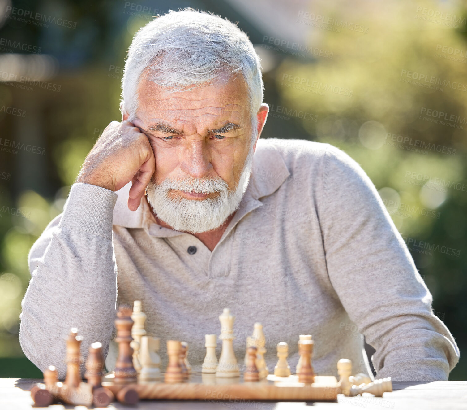 Buy stock photo Senior man, chess and alone with thinking for strategy, outdoor for mental solution to challenge. Male person, park and board game with planning, problem solving with cognitive skills in retirement