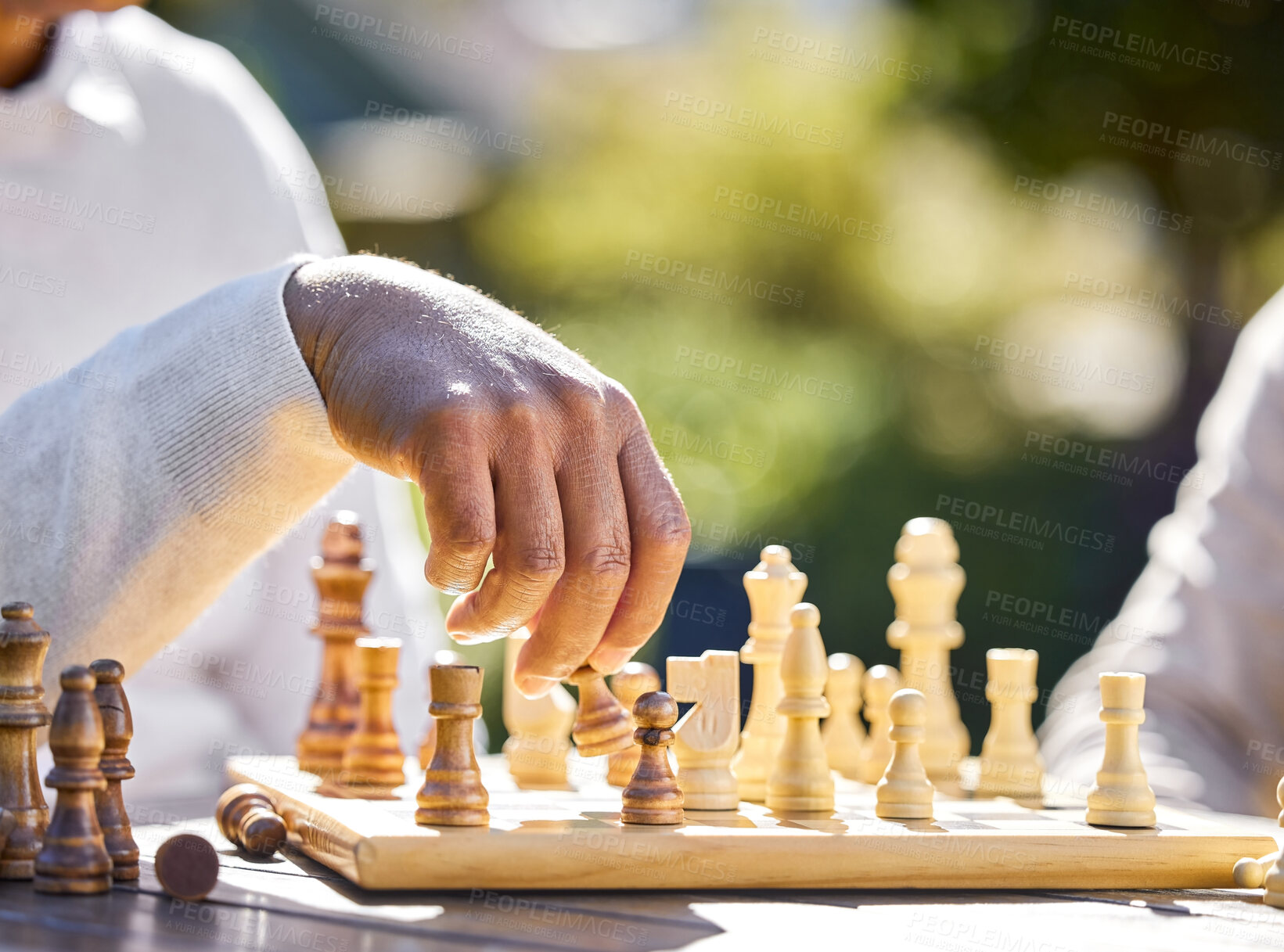 Buy stock photo Cropped shot of two unrecognisable men sitting inside together and playing a game of chess