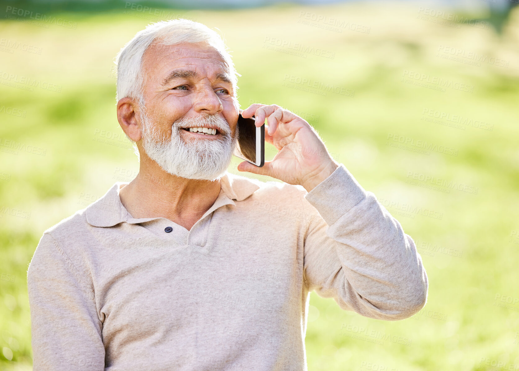 Buy stock photo Shot of a senior man sitting alone outside and using his cellphone