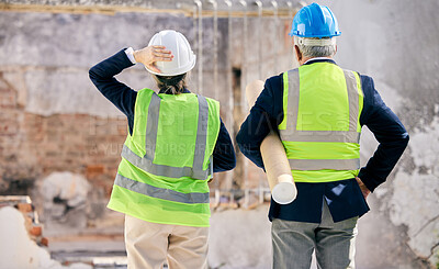 Buy stock photo Shot of  engineers standing with blueprints on a construction site