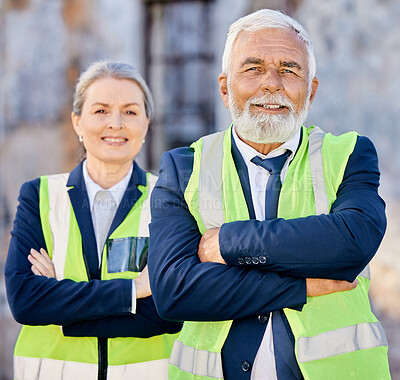 Buy stock photo Shot of engineers standing with their arms folded on a construction site