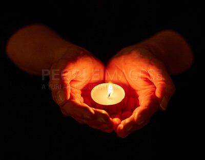 Buy stock photo Shot of a unrecognizable person holding a candle in the dark