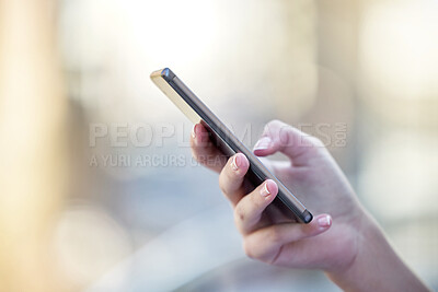 Buy stock photo Hand, phone and communication with a woman typing a text message closeup on a blurred background. Mobile, contact and social media with a female person reading a text or networking alone outdoor