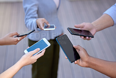 Buy stock photo Shot of a group of business people holding an array of smartphones