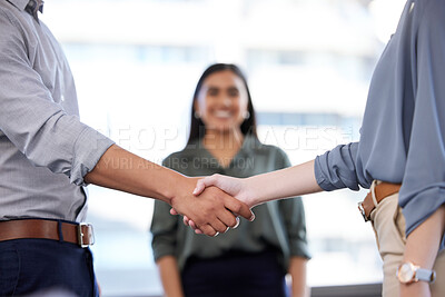 Buy stock photo Shot of an unrecognisable businesswoman and businessman shaking hands in a modern office
