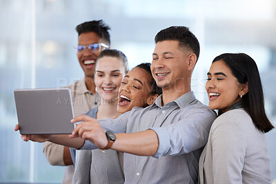 Buy stock photo Shot of a group of young businesspeople taking selfies with a digital tablet in a modern office