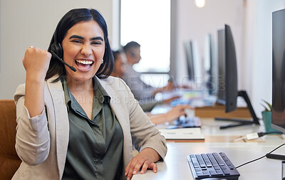 Buy stock photo Portrait of a young call centre agent cheering while working in an office