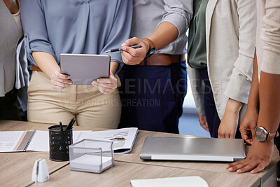 Buy stock photo Shot of a group of unrecognizable businesspeople using a digital tablet in an office at work