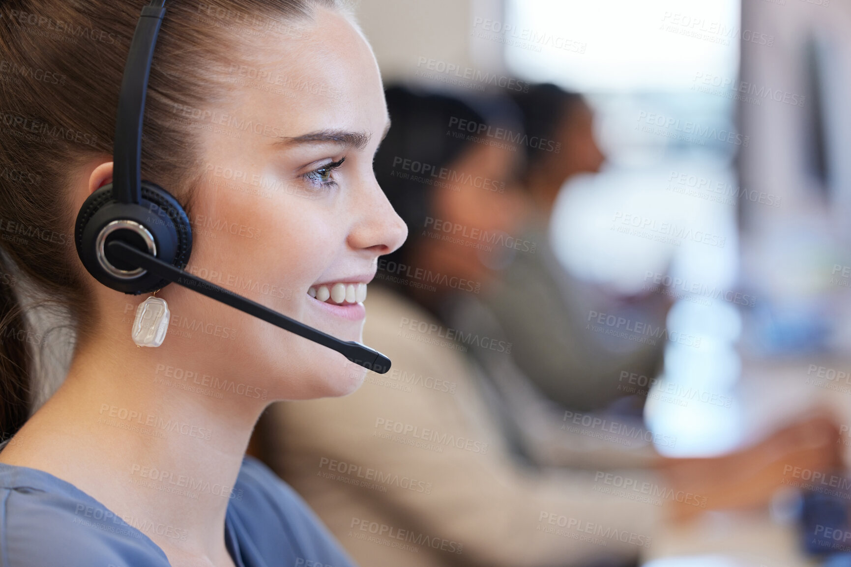 Buy stock photo Shot of a young call centre agent working in an office