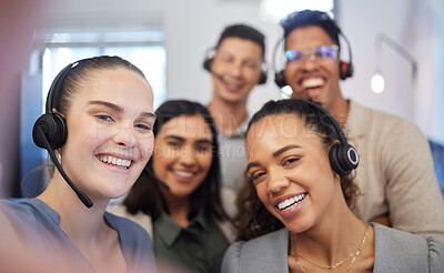 Buy stock photo Portrait of a group of call centre agents taking selfies in an office