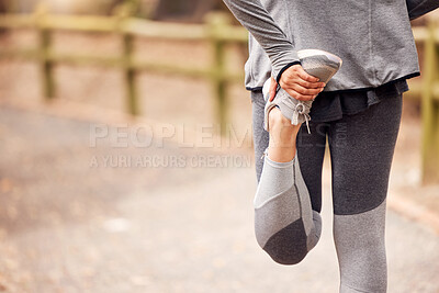 Buy stock photo Shot of an unrecognisable woman stretching before her workout in nature