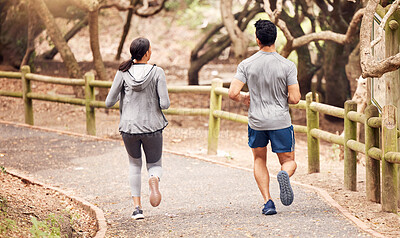 Buy stock photo Shot of an unrecognisable man and woman going for a run in nature