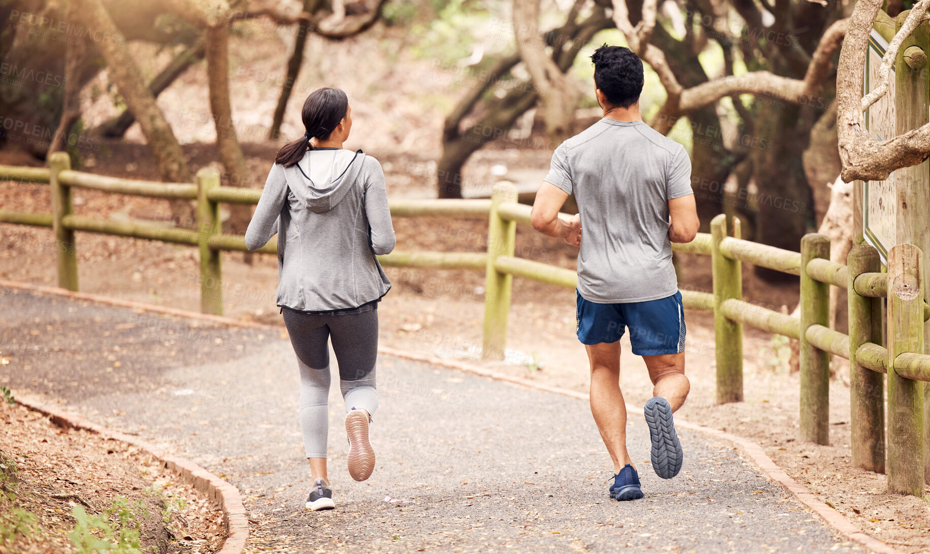 Buy stock photo Running, back and fitness of couple, outdoor and active for performance, road and exercise for body. Street, athlete and people together, healthy and training with workout, action and path in park