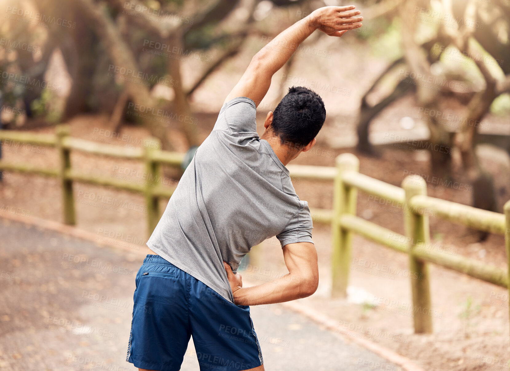 Buy stock photo Stretching, back and man in road, outdoor and fitness for athlete in nature, wellness and exercise. Park, healthy and person with performance, warm up and flexible in weekend, sport and active