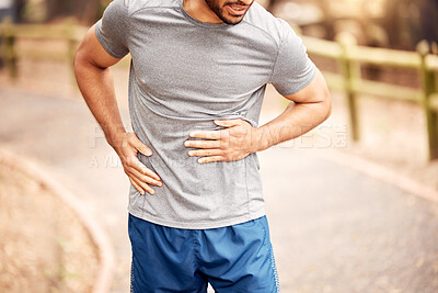 Buy stock photo Stomach pain, fitness hands and man outdoor after running, workout and exercise. Sports, abdomen ache and male athlete in nature with injury, emergency hernia or problem, sick or training accident.