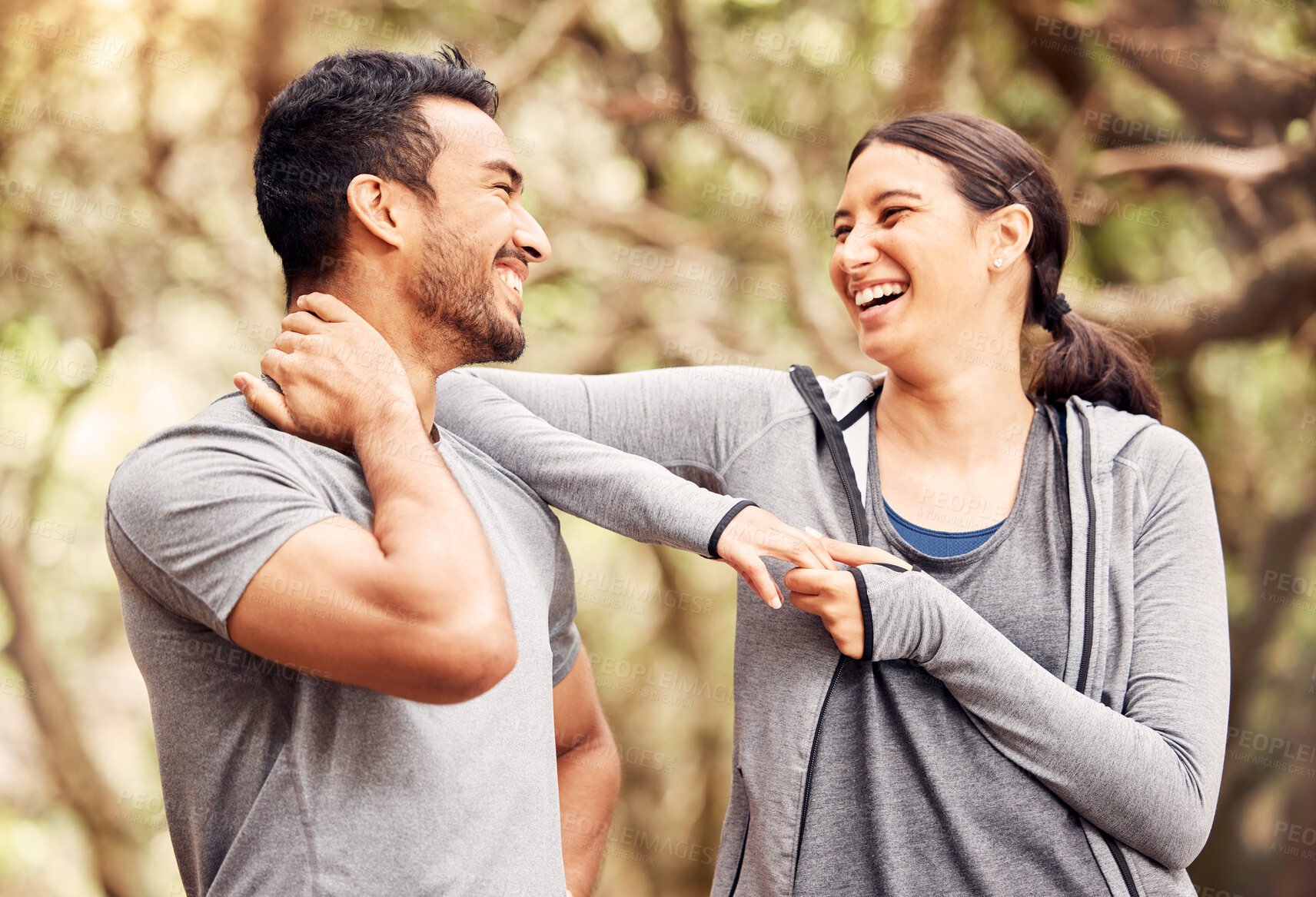 Buy stock photo Shot of a young man and woman going for a run in nature