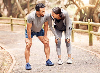 Buy stock photo Shot of a young man and woman going for a run in nature