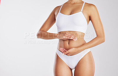 Buy stock photo Cropped shot of a woman forming a frame over her stomach