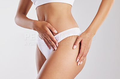 Buy stock photo Cropped shot of a fit young woman showing off her thighs