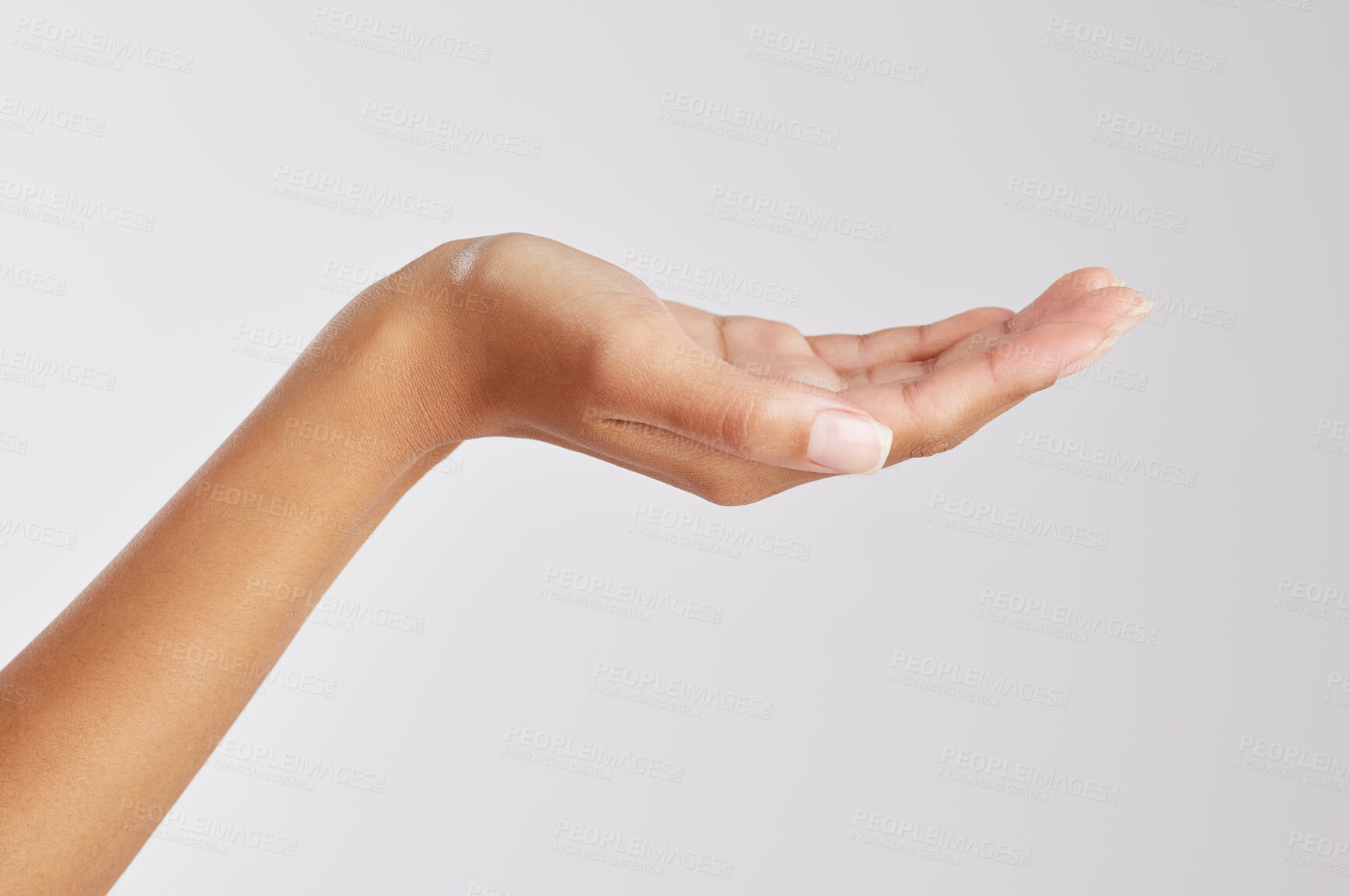 Buy stock photo Cropped shot of an unrecognizable holding out her hand against a studio background