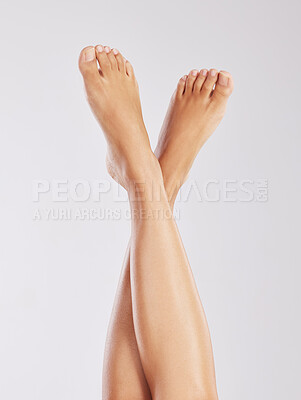 Buy stock photo Cropped shot of a young woman showing off her legs  against a white background