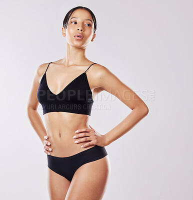 Buy stock photo Shot of a young woman posing in her underwear against a white background