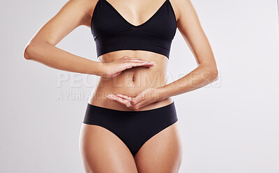Buy stock photo Cropped shot of a woman forming a frame over her stomach