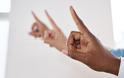 Buy stock photo Shot of a group of unrecognisable businesspeople pointing during a meeting in a modern office