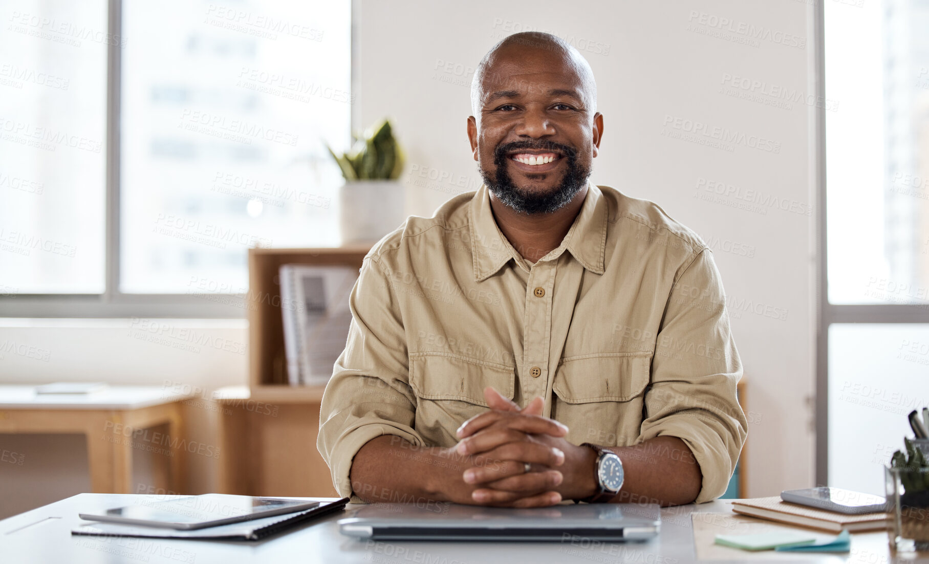 Buy stock photo Portrait of a mature businessman working at his desk in a modern office