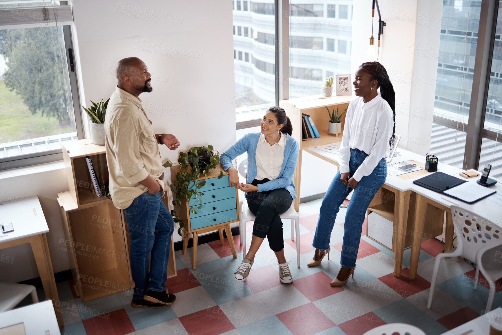 Buy stock photo Shot of a group of businesspeople having a discussion in a modern office