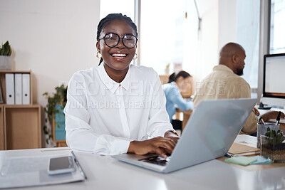 Buy stock photo Shot of a young businesswoman using a laptop in a modern office