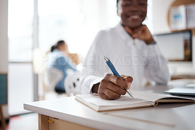 Buy stock photo Shot of a young businesswoman writing in a notebook in a modern office