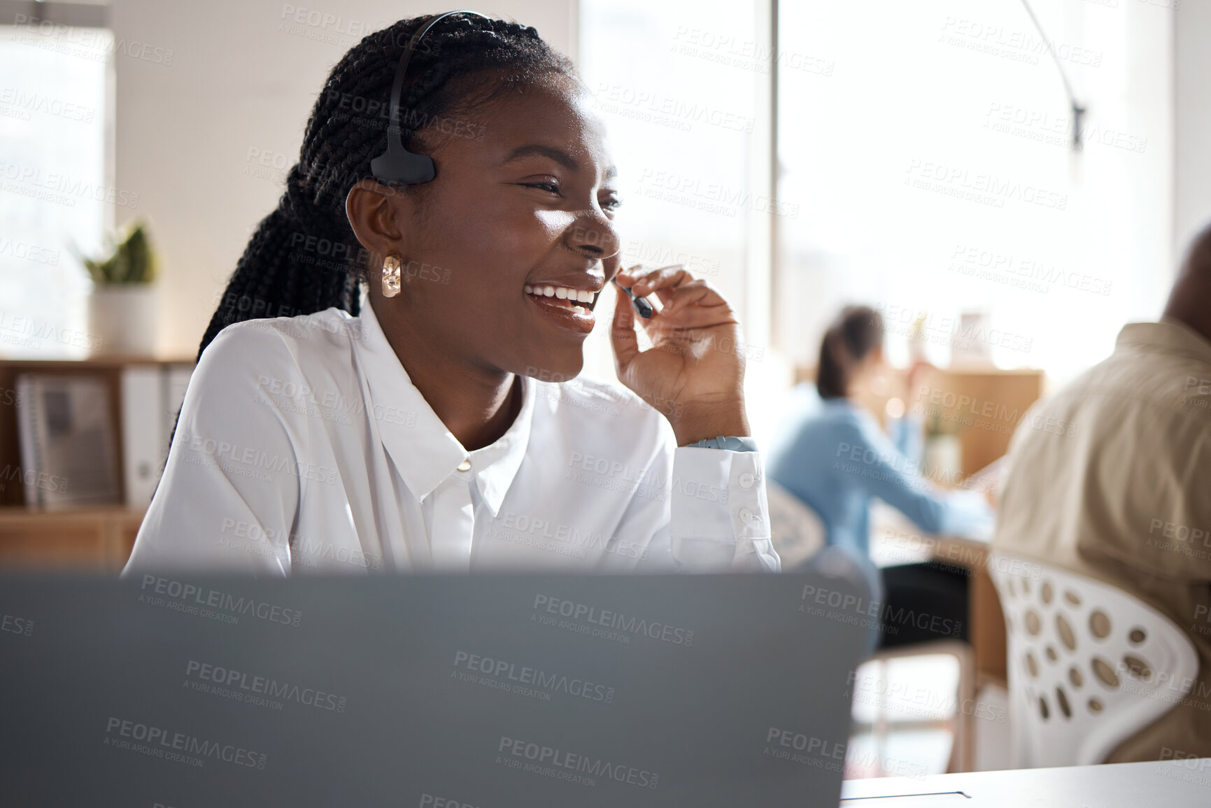 Buy stock photo Shot of a young businesswoman using a headset and laptop in a modern office