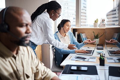 Buy stock photo Shot of two businesswomen using a headset and computer while working in a modern office