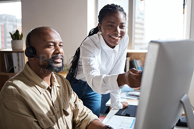 Buy stock photo Shot of a businessman and businesswoman using a headset and computer while working in a modern office