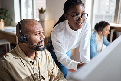 Buy stock photo Shot of a businessman and businesswoman using a headset and computer while working in a modern office