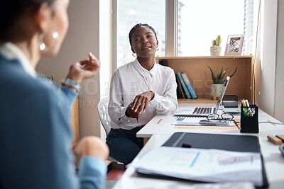 Buy stock photo Shot of a two young businesswomen having a conversation in a modern office
