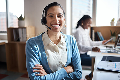 Buy stock photo Shot of a young businesswoman using a headset in a modern office with her colleagues working in the background