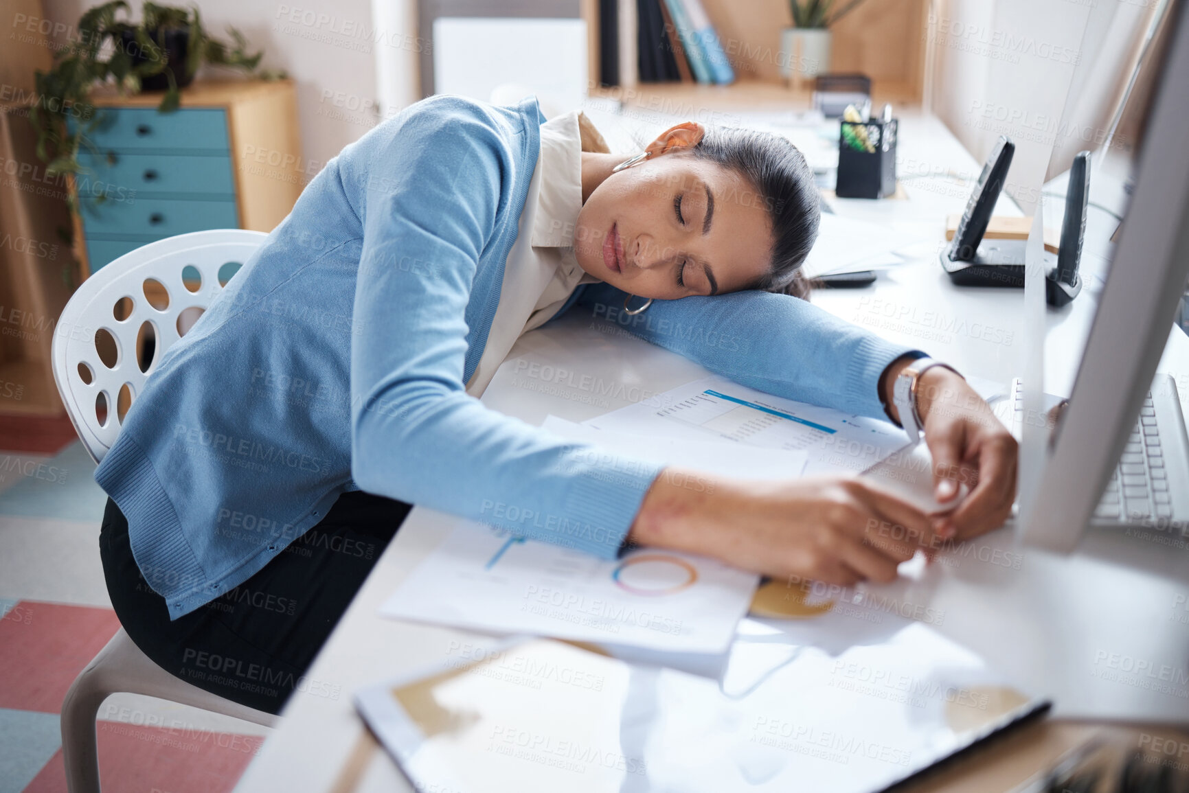 Buy stock photo Shot of a young businesswoman sleeping at her desk in a modern office