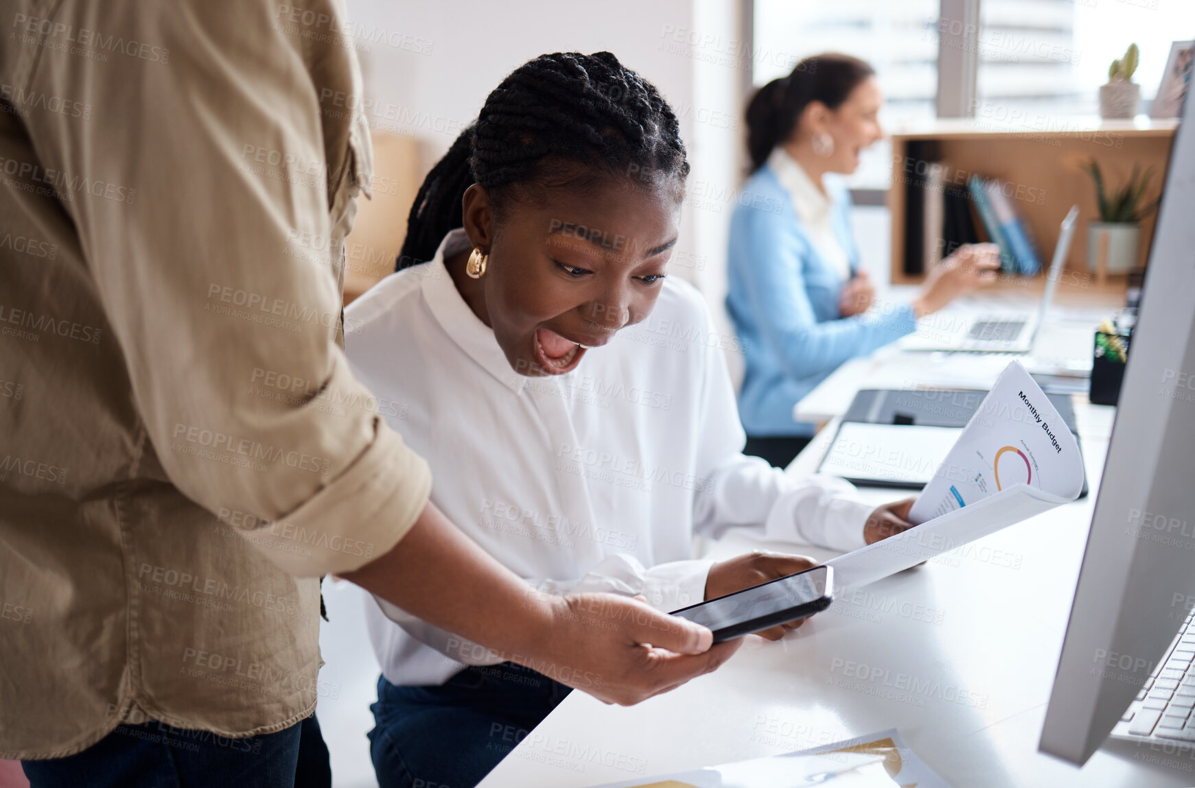 Buy stock photo Shot of a young businesswoman discussing paperwork with her colleague and looking shocked in a modern office