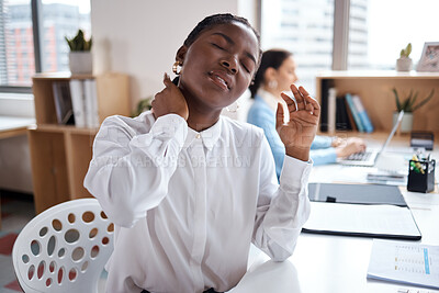 Buy stock photo Shot of a young businesswoman experiencing neck pain while working at her desk in a modern office