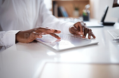 Buy stock photo Shot of an unrecognisable businesswoman using a digital tablet at her desk in a modern office