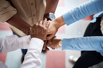 Buy stock photo Shot of a group of unrecognisable businesspeople joining their hands in solidarity in a modern office