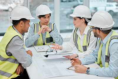 Buy stock photo Cropped shot of a group of young constructions having a meeting on their building site